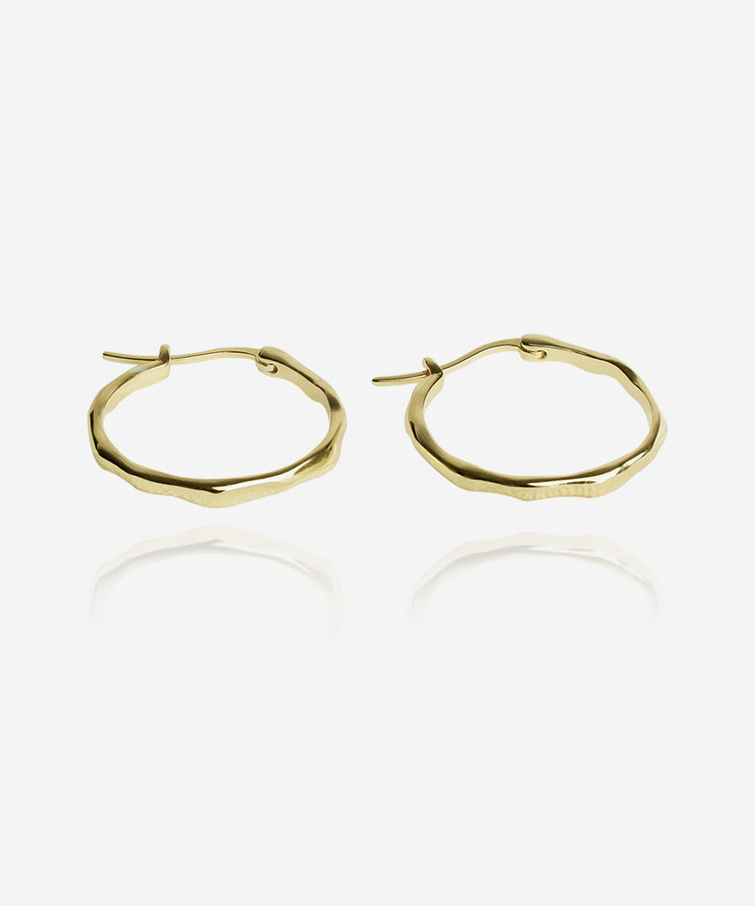 Minimal earrings. beautiful circular shaped gold earrings on white background