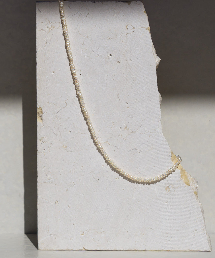 Tyarah pearl necklace on a marble stone