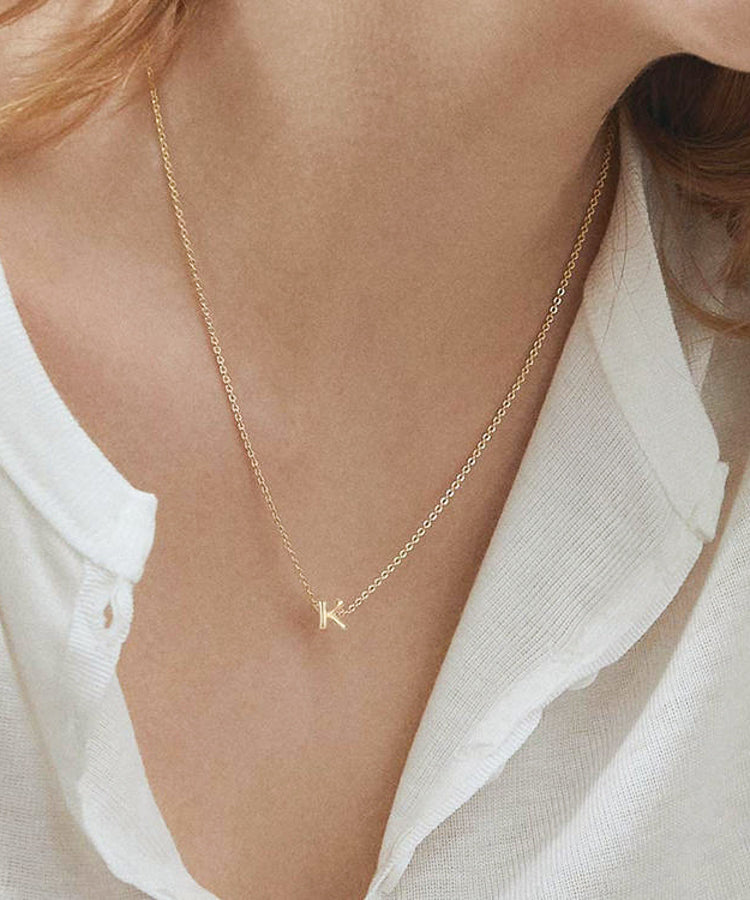 Model wearing initial alphabet 18k gold plated pendant