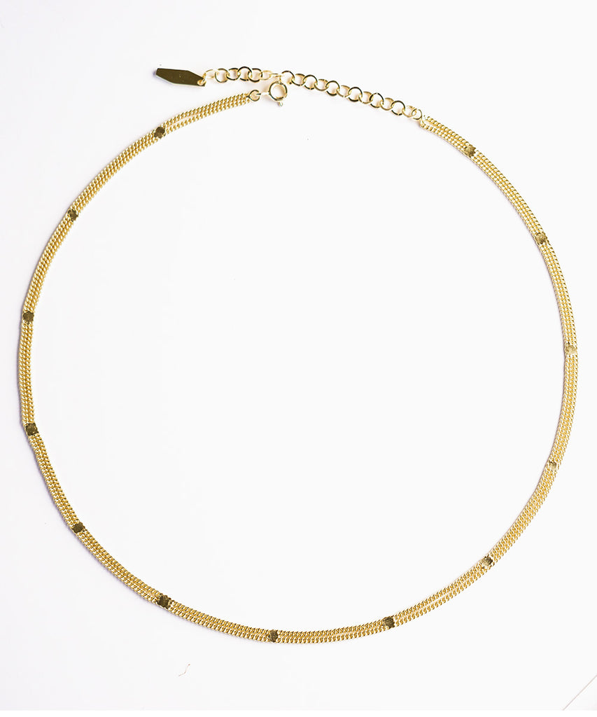 Belva gold necklace on white background