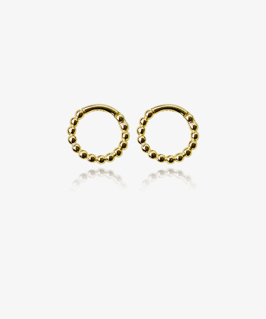 Gold plated 925 sterling silver Coralia huggie earrings on white background