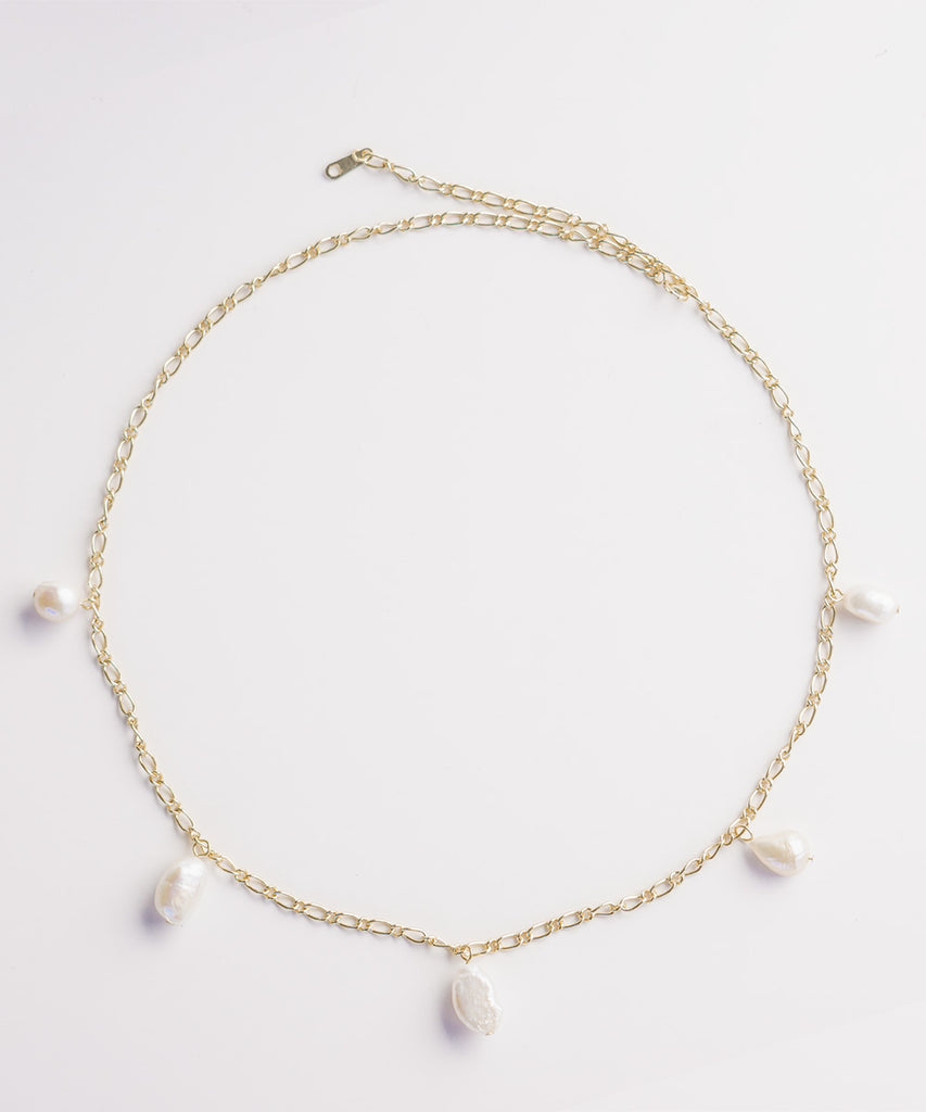 Gold Thalassa necklace with pearls on white background